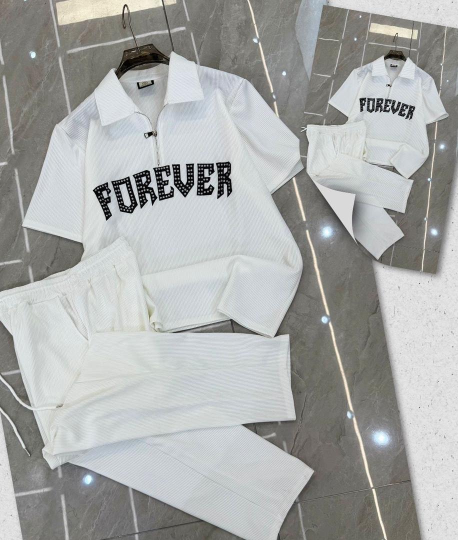 White ribbed polo and pants set displaying FOREVER studded graphic.