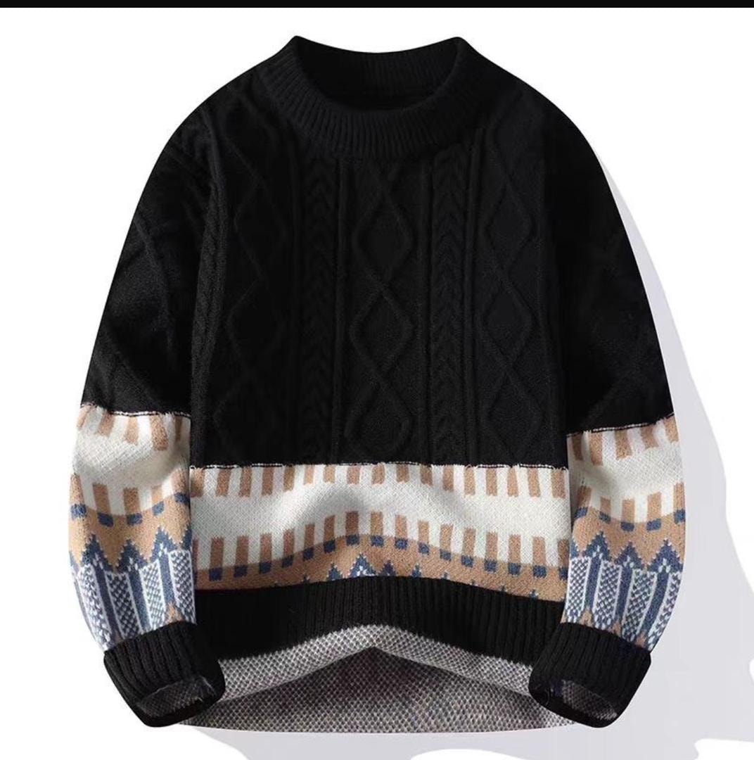 Black knit sweatshirt with lower beige blue white patterned band and cable knit upper on white background.
