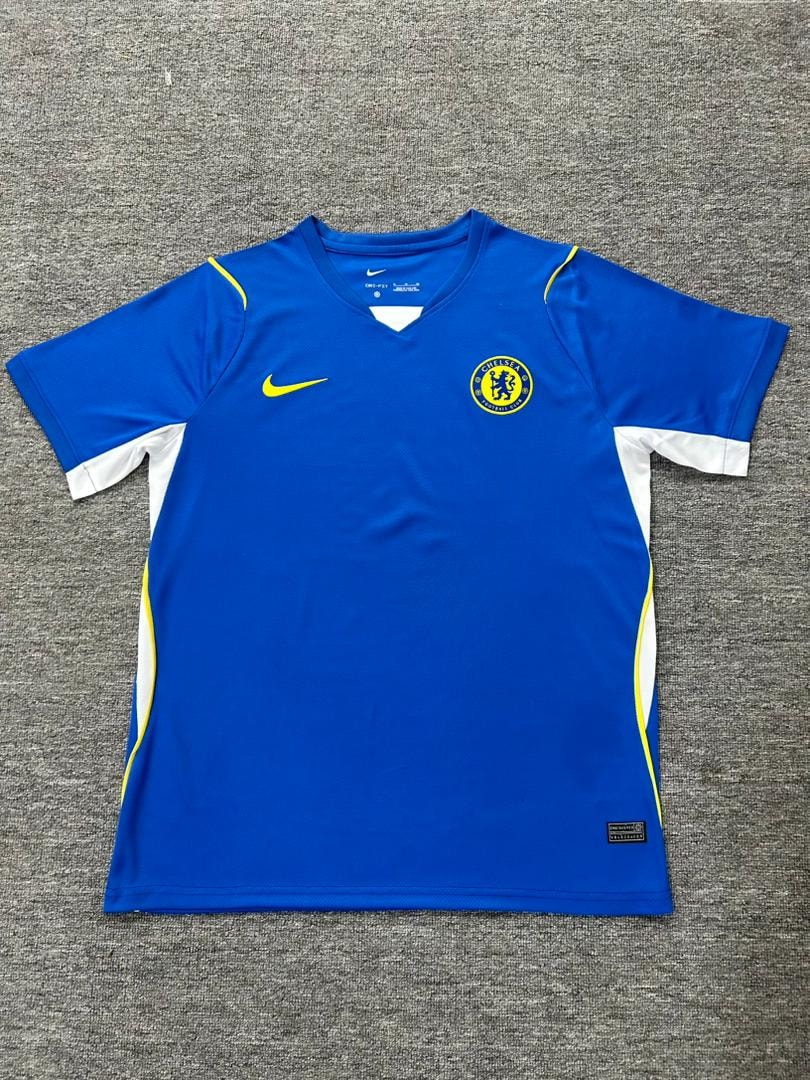 Blue Chelsea FC Nike football jersey laid flat on a grey surface.