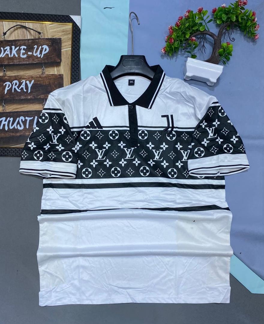 White and black patterned Juventus polo jersey displayed on hanger with background decorations.