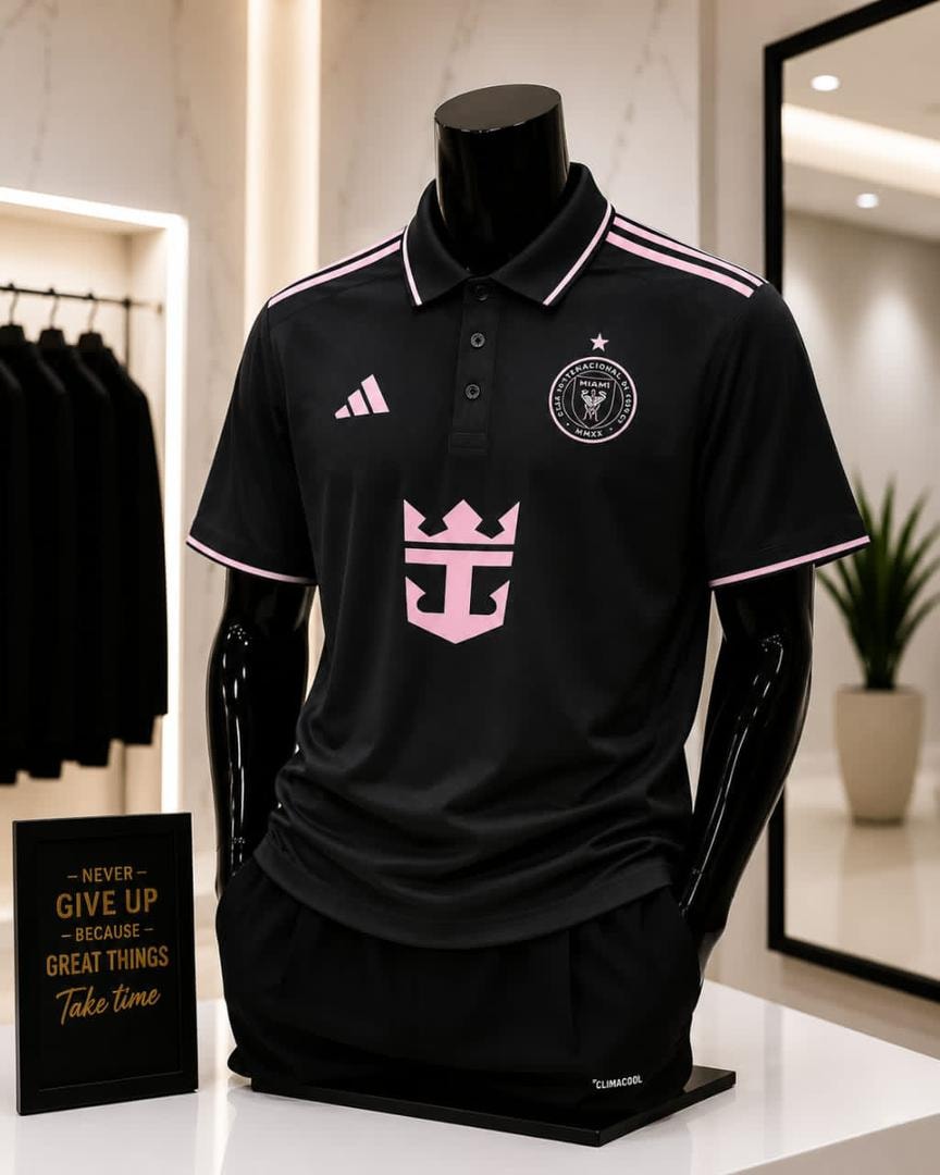 Black Inter Miami polo jersey displayed on mannequin in modern retail store.