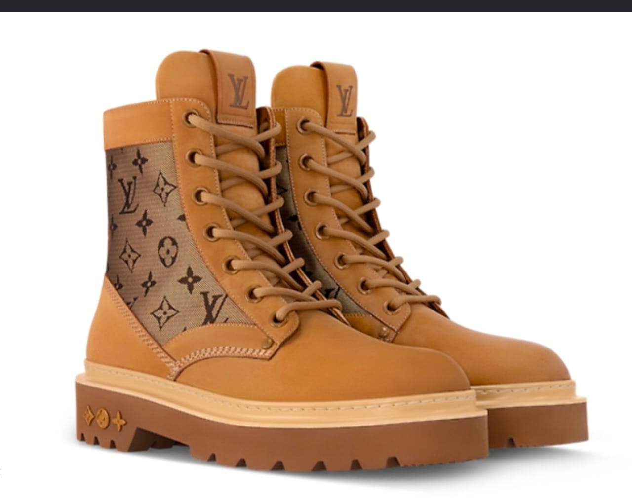 Pair of tan Louis Vuitton boots with monogram panel, LV logos and chunky brown sole on white background.