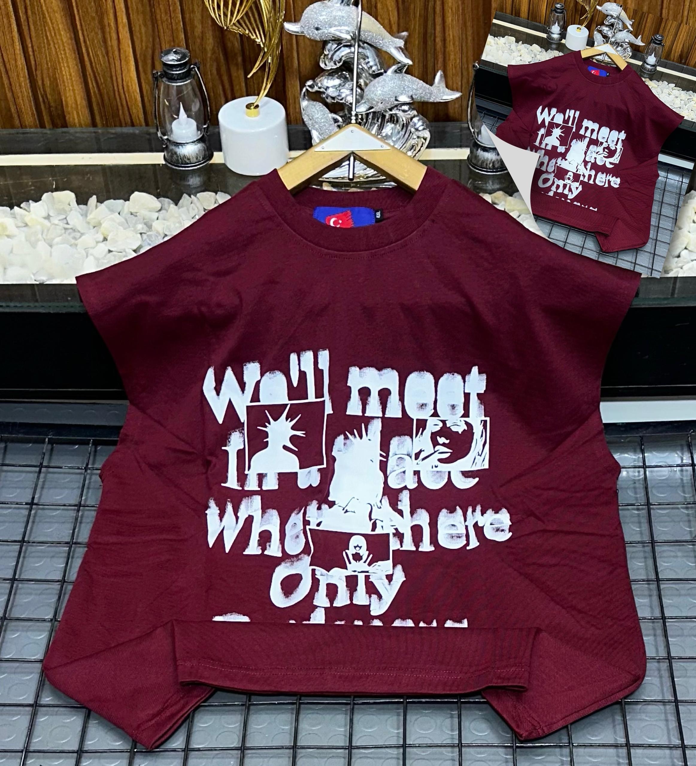 Burgundy armless graphic t-shirt laid flat showing front print.