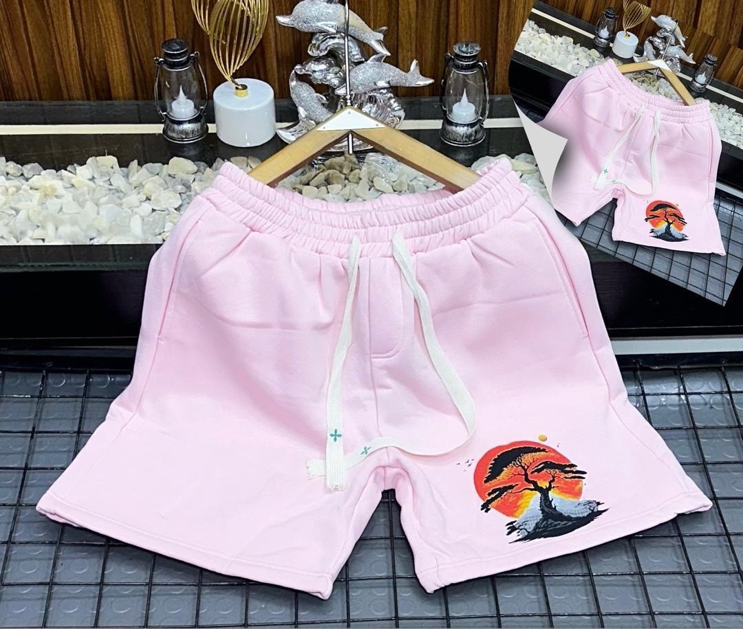 Pink unisex shorts with sunset tree graphic print.