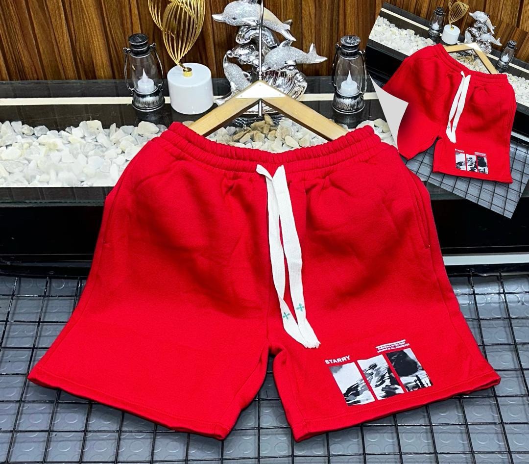 Red unisex shorts with starry landscape photo print.