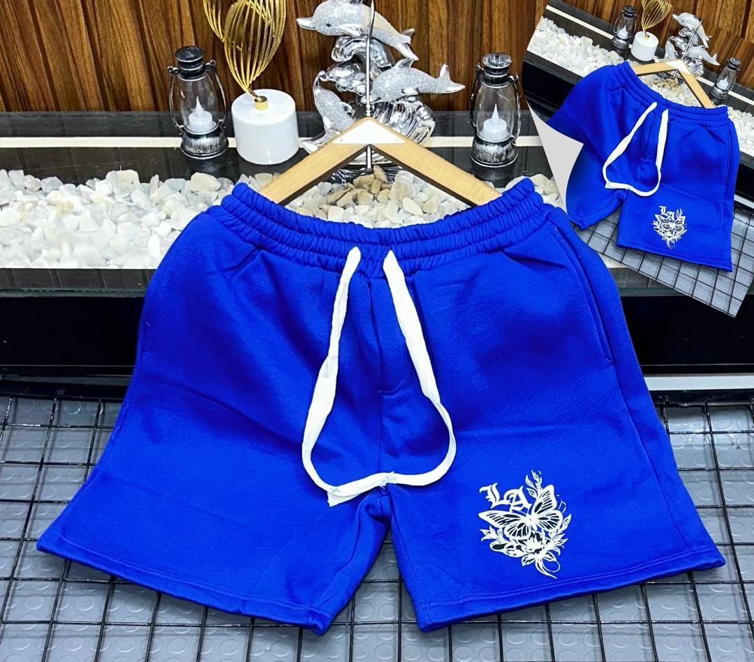 Blue unisex shorts with white butterfly embroidery on leg.
