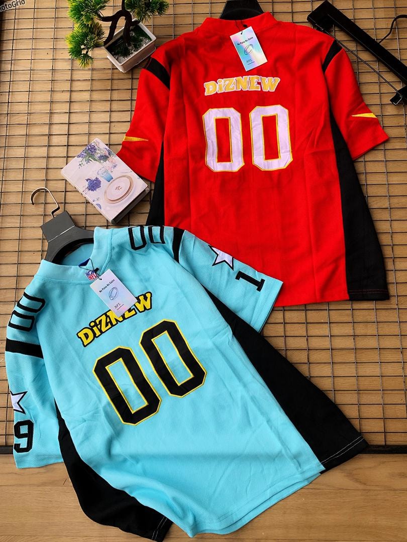 Red/black and light blue/black Diznew 00 football jerseys on wooden surface with props.
