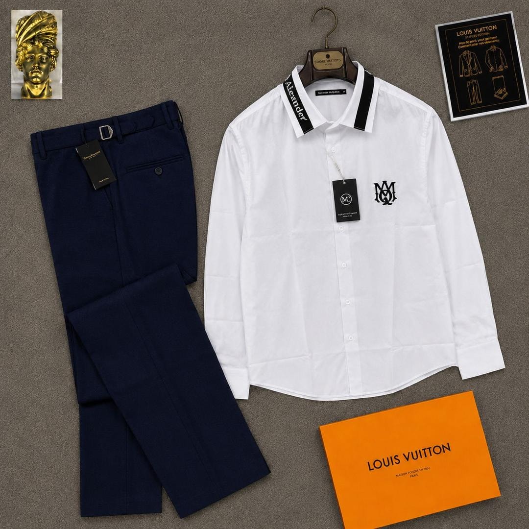 White long sleeve McQueen logo shirt paired with navy trousers and orange box.