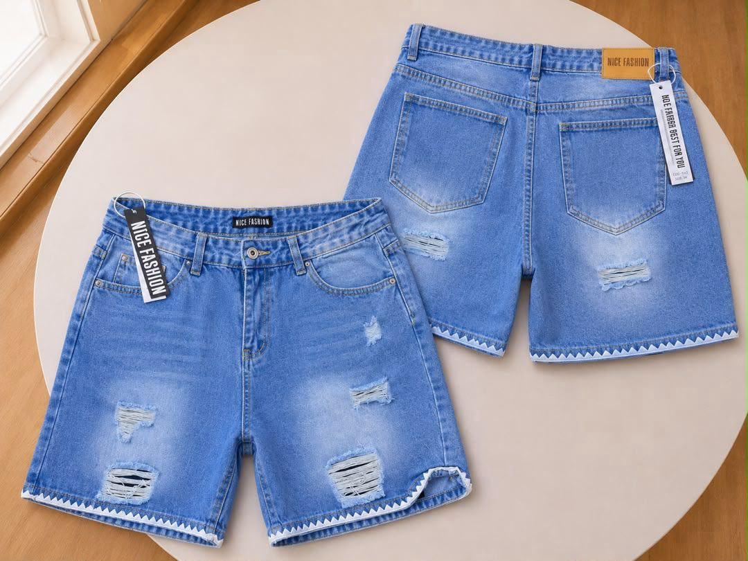 Front and back of light blue denim shorts with zigzag hem and rips.