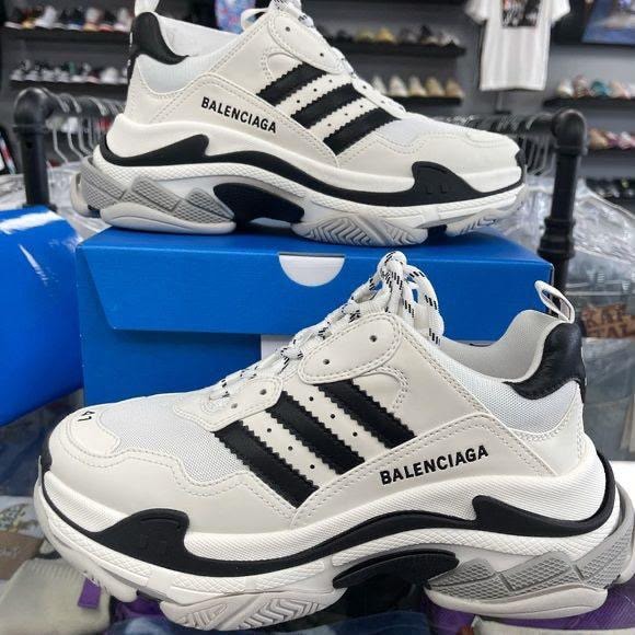 White and black Balenciaga sneakers shown from side and front angles on a blue box.