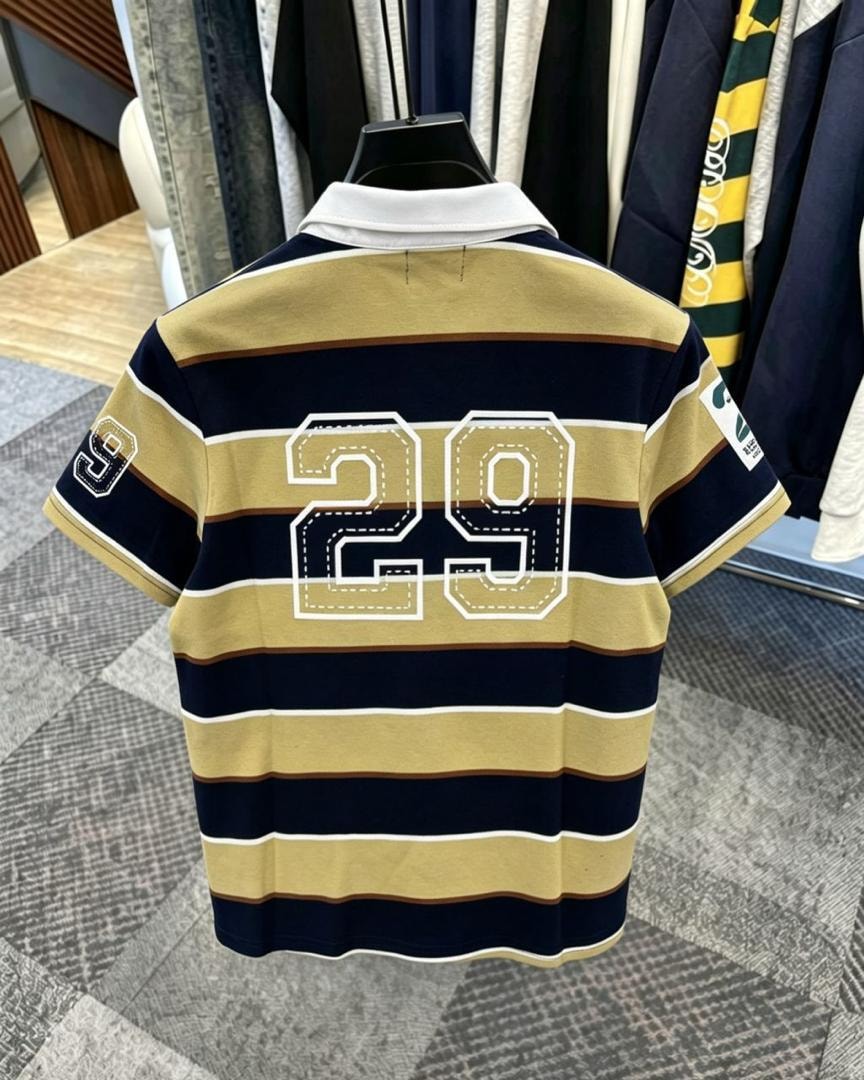 Back view of beige striped polo shirt showing large 29 embroidery.