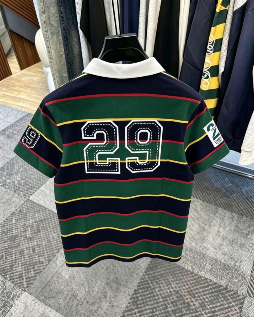 Back view of green striped polo shirt showing large 29 embroidery.