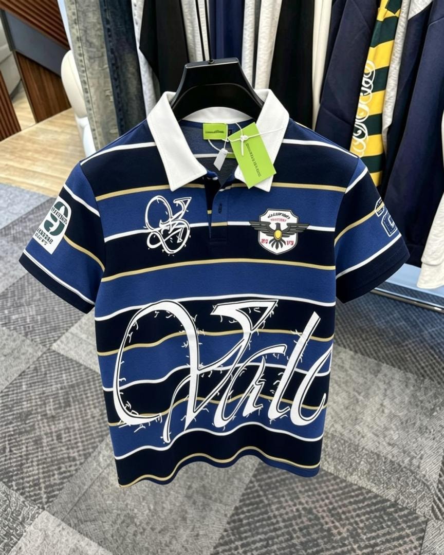 Front view of blue striped polo shirt with white collar, chest embroidery and logos.