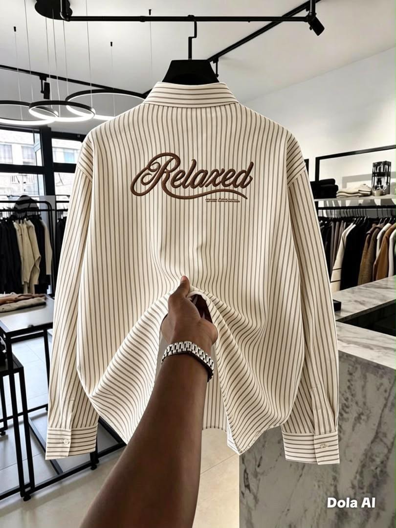 Back view of beige and brown striped button-down shirt with large Relaxed embroidery.