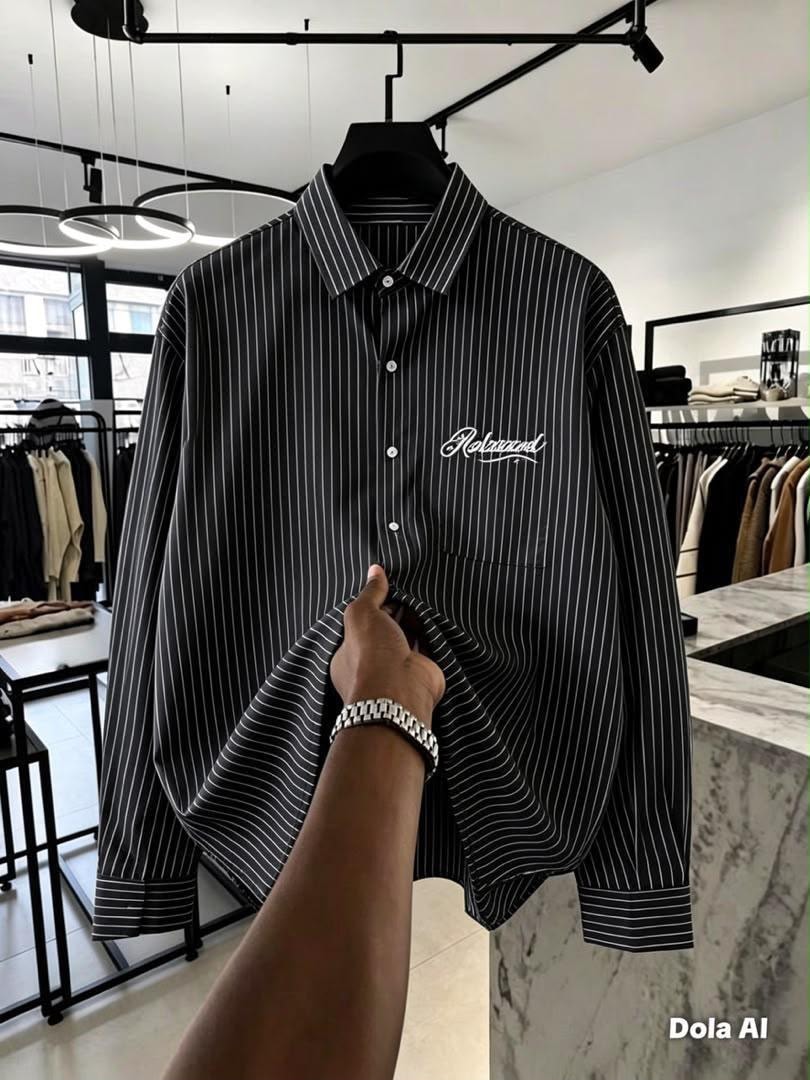 Front view of black and white striped button-down shirt with Relaxed chest embroidery held in store.