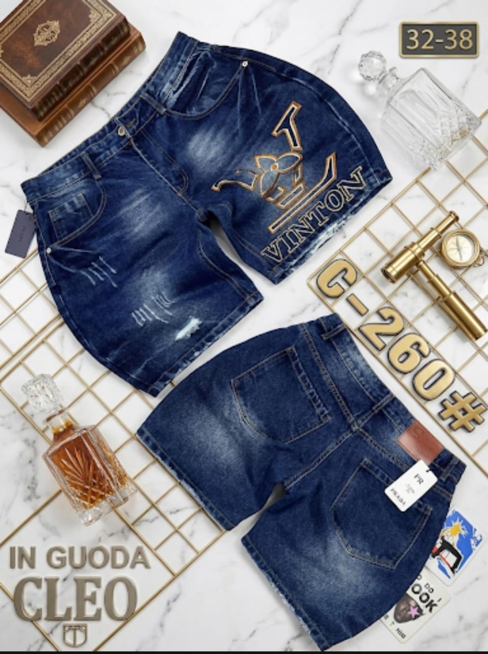 Front and back views of blue denim shorts with embroidery on marble grid with decorative items.