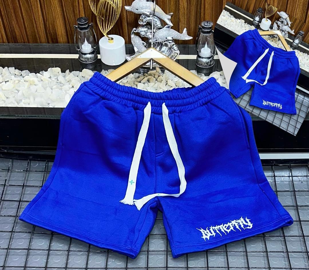 Blue fleece shorts with white gothic Butterfly print on leg.