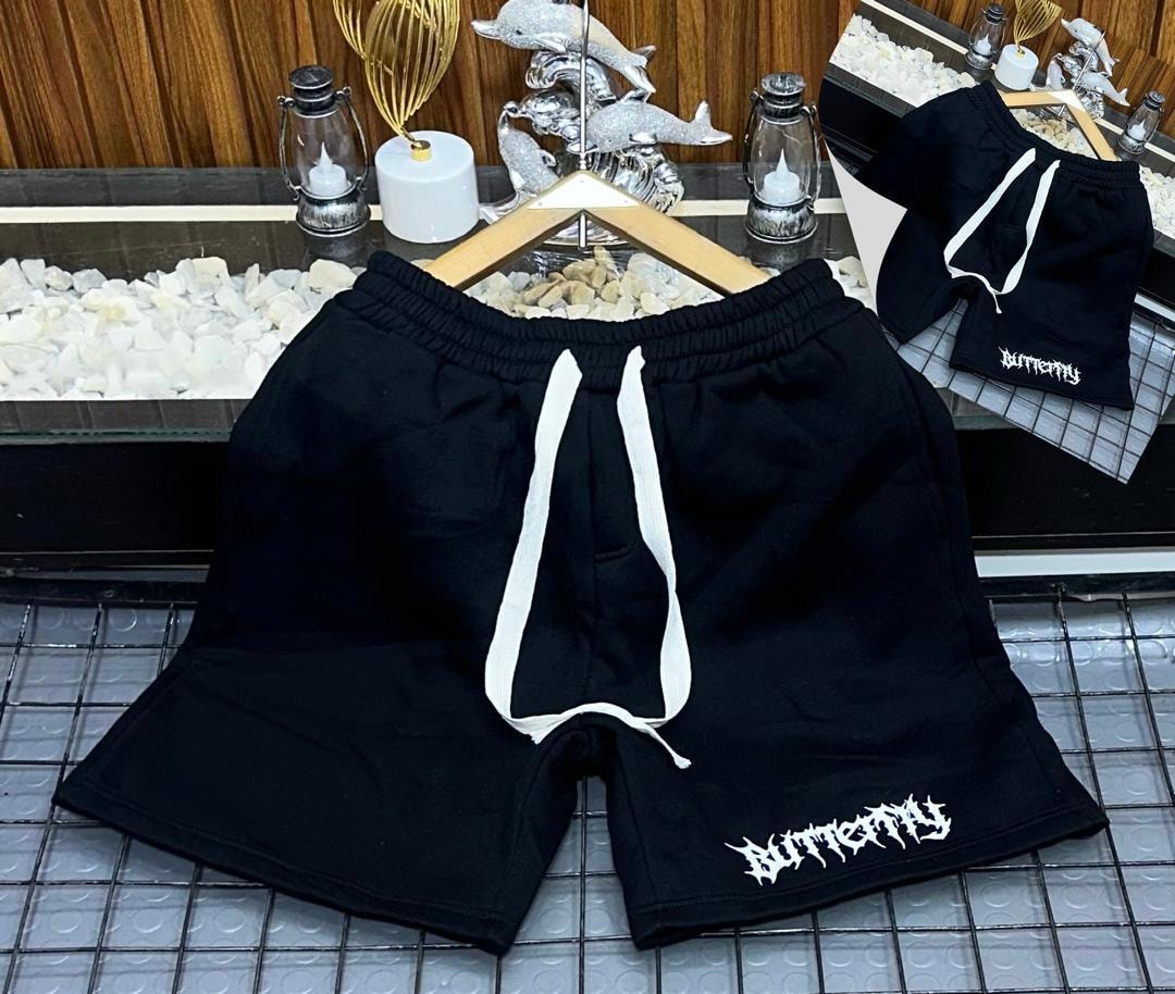 Black fleece shorts with white gothic Butterfly print on leg.