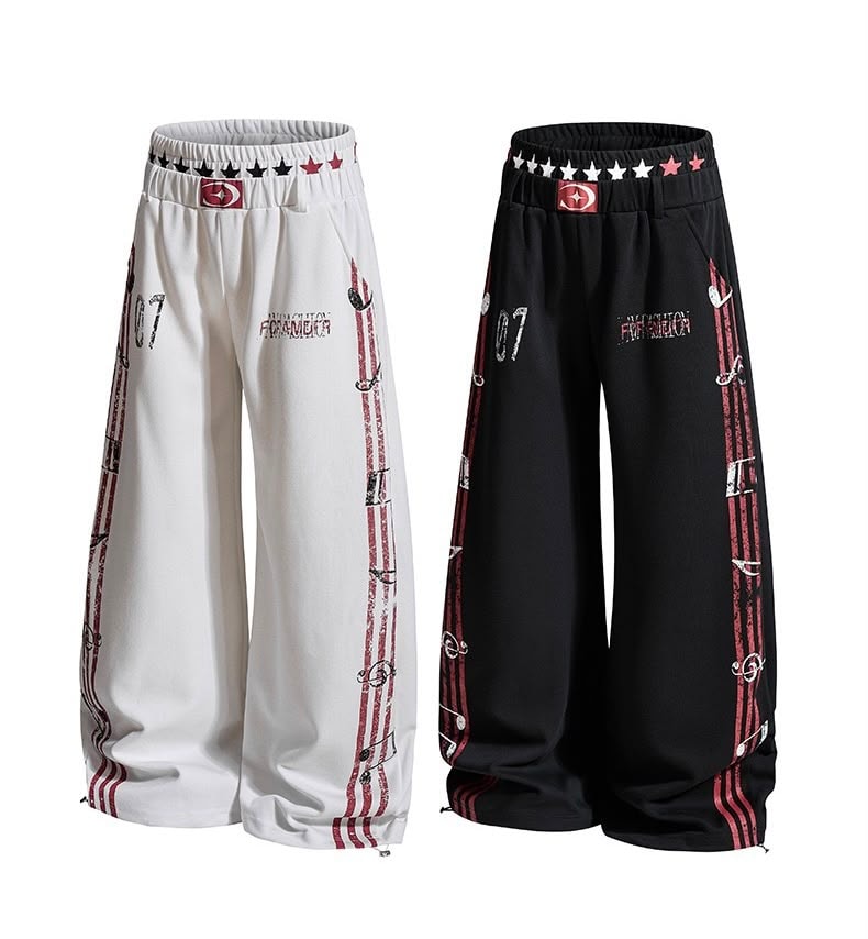 White and black graphic joggers shown side by side on white background.