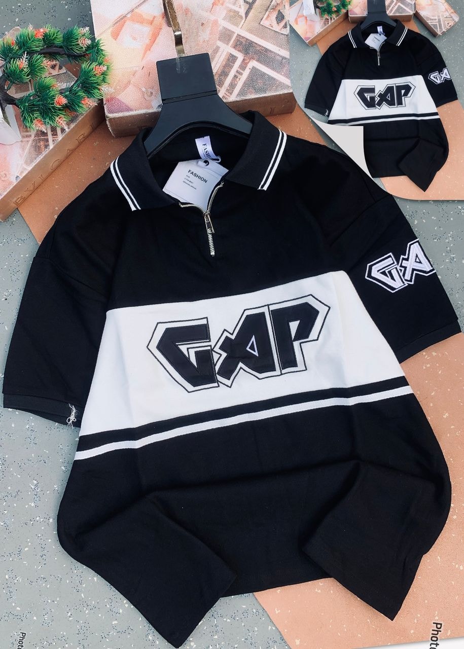 Black and white GAP colorblock quarter-zip polo shirt displayed with large logo and striped accents.
