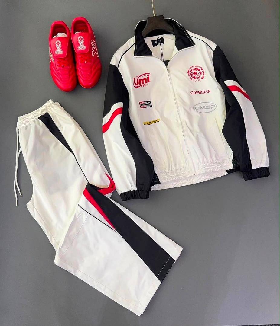 White black and red two-piece tracksuit with red sneakers.