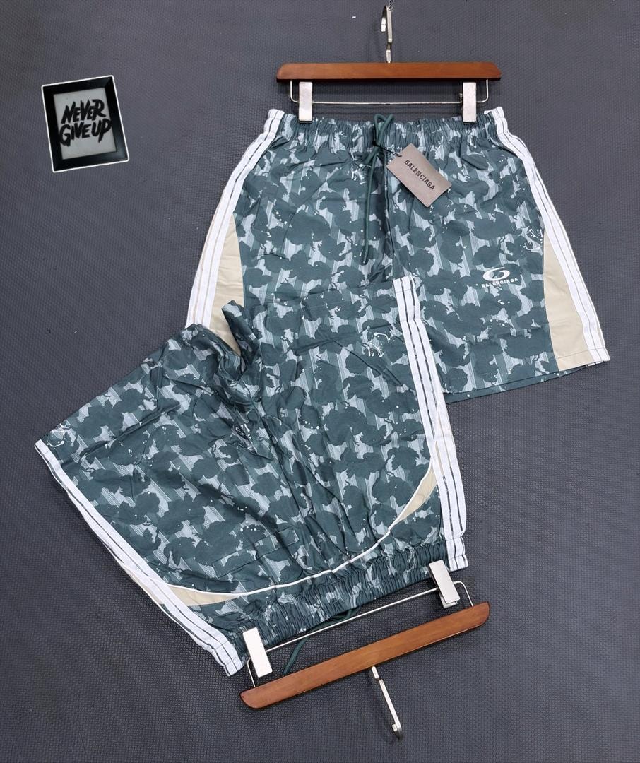 Green camo Balenciaga shorts on hanger and flat lay showing tag.