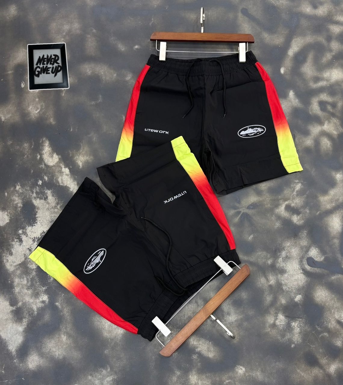 Black Litework gradient track shorts on hanger and flat lay.