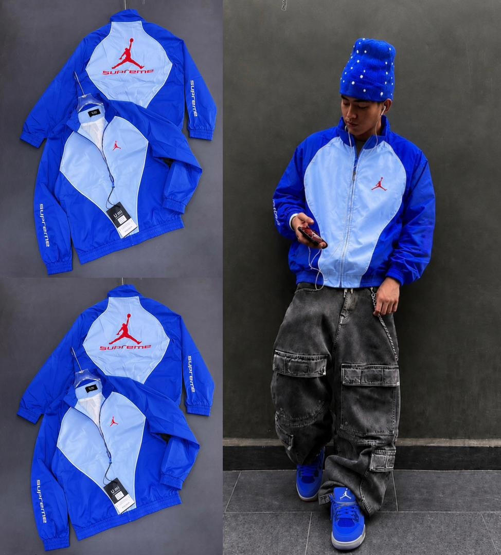 Blue and light blue Supreme Jordan jacket in flat lays and worn by model against wall.