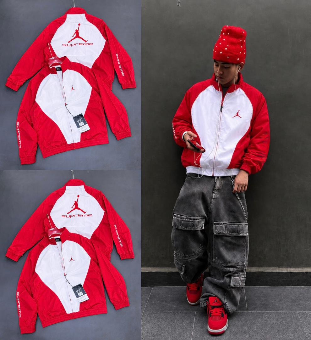 Red and white Supreme Jordan jacket in flat lays and worn by model against wall.