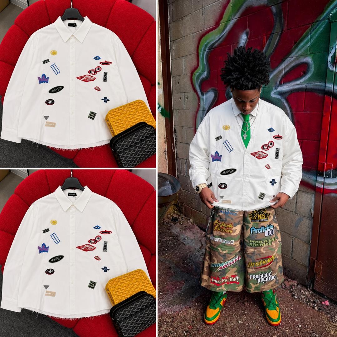 White Marc Lewis patch shirt on red couch and modeled with camo pants.