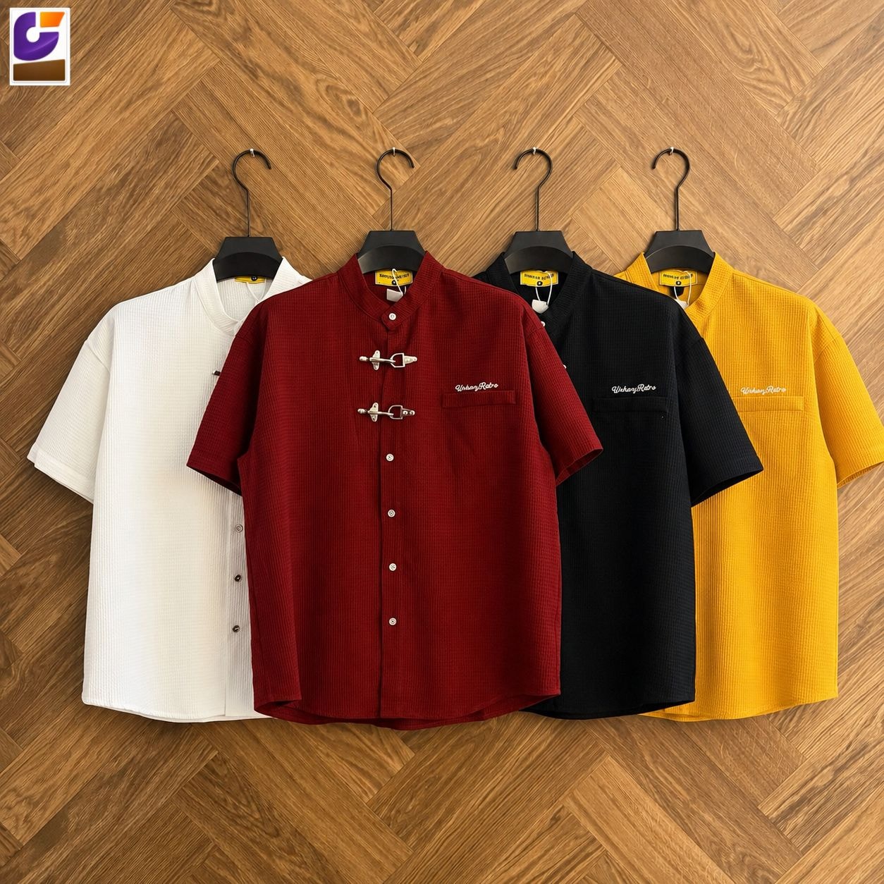White, red, black and yellow waffle knit frog button shirts hanging side by side.