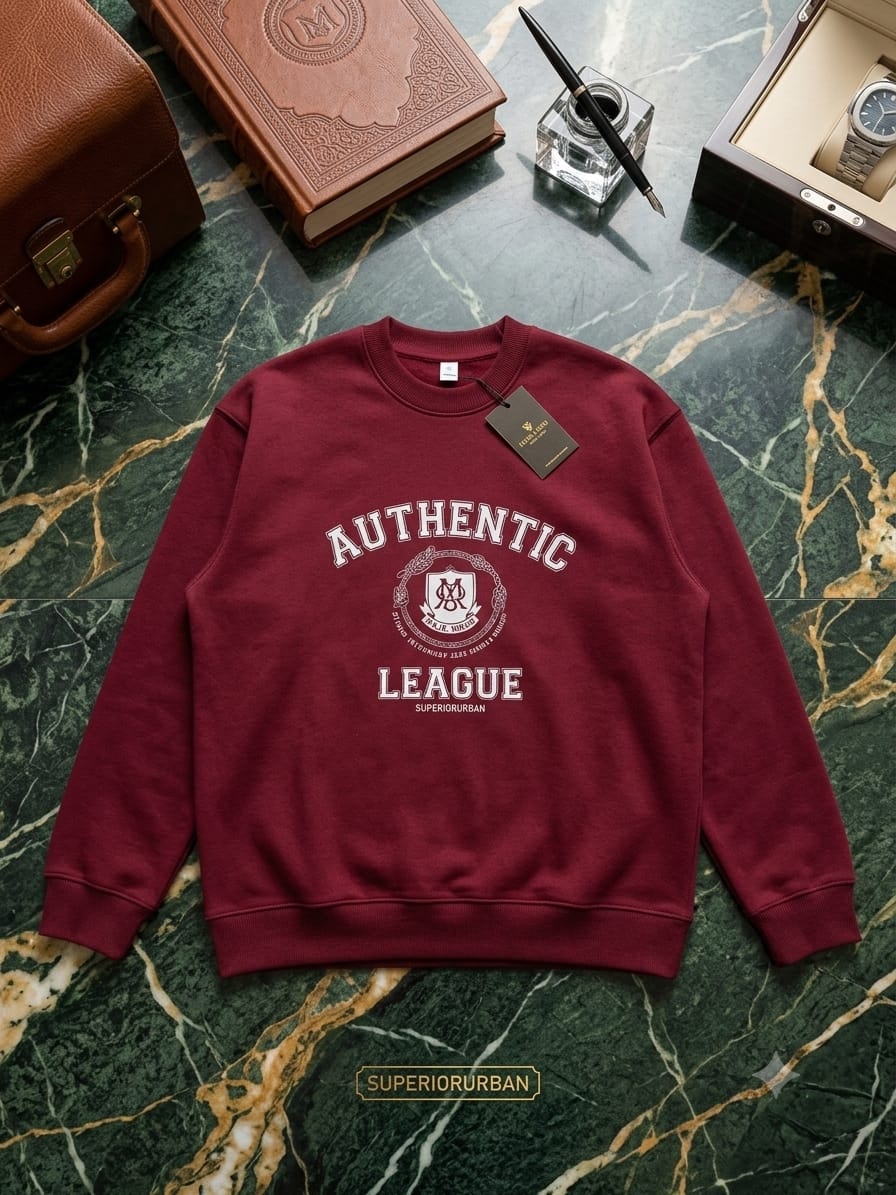 Maroon sweatshirt with Authentic League crest and text on green marble with luxury props.
