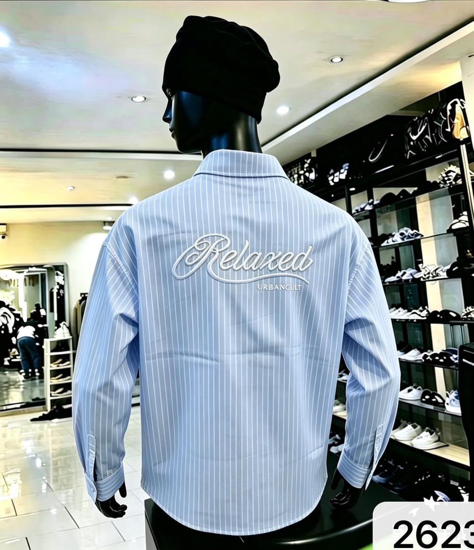 Back view of light blue striped shirt with white Relaxed URBANCHILL embroidery.