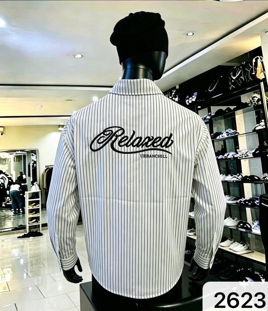 Back view of white and black striped shirt with large black Relaxed URBANCHILL embroidery.
