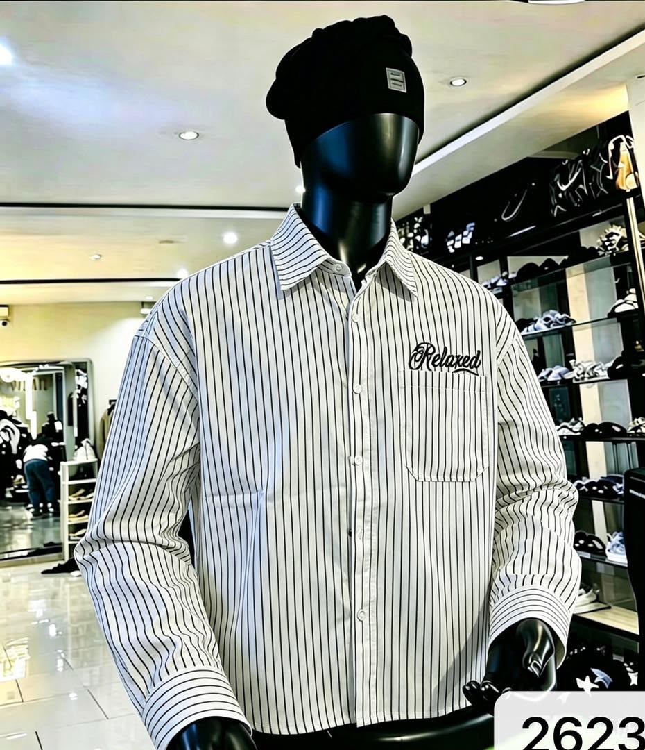 Front view of white and black striped shirt with black Relaxed chest embroidery on mannequin.