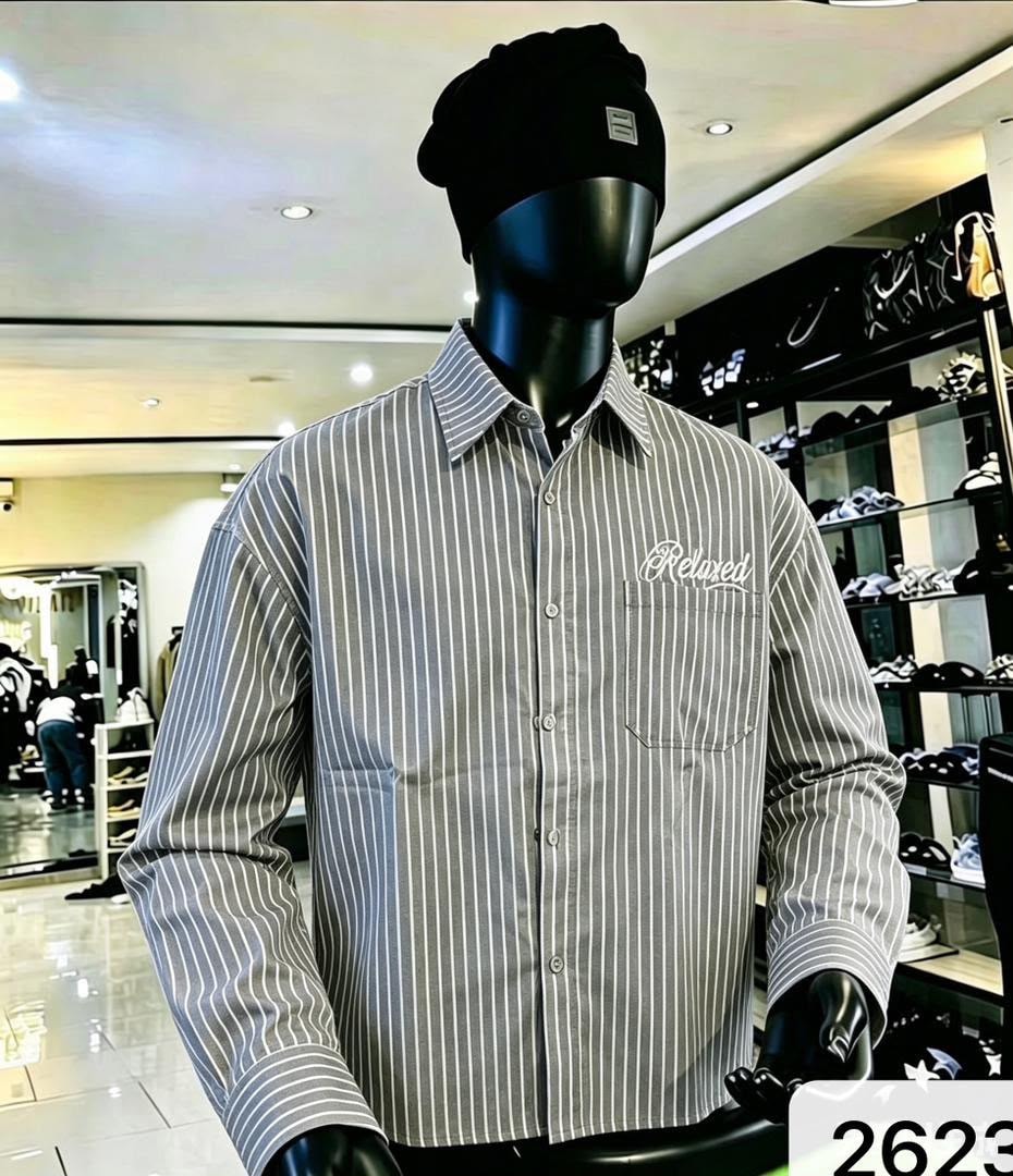 Front view of gray striped shirt with white Relaxed embroidery on mannequin.