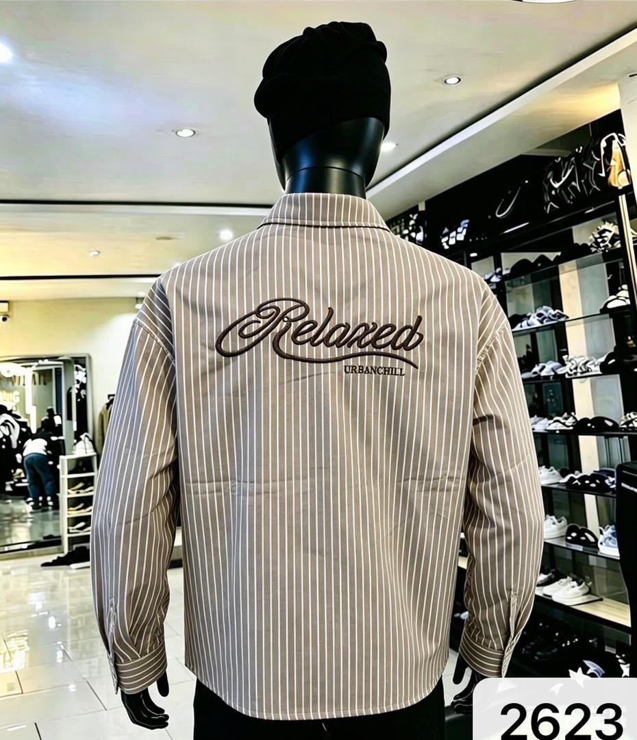 Back view of mannequin in beige striped shirt with large Relaxed URBANCHILL embroidery.
