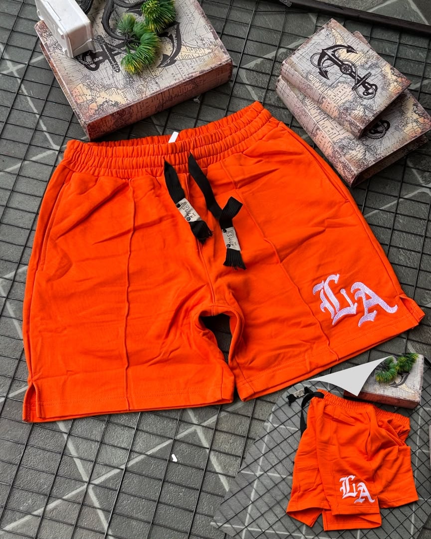 Orange LA embroidered fleece shorts with tags and matching smaller pair.