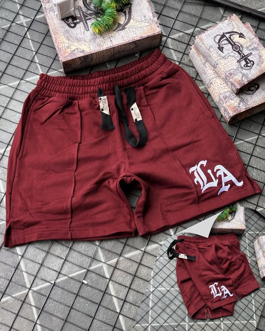 Burgundy LA embroidered fleece shorts showing logo and waistband details.