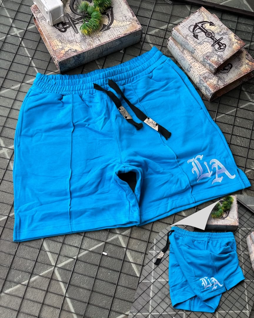 Light blue LA embroidered fleece shorts laid flat with tags and smaller pair.