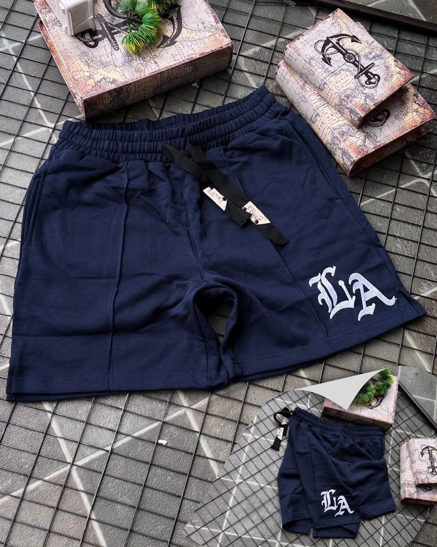 Navy LA embroidered fleece shorts with white logo and drawstring detail.