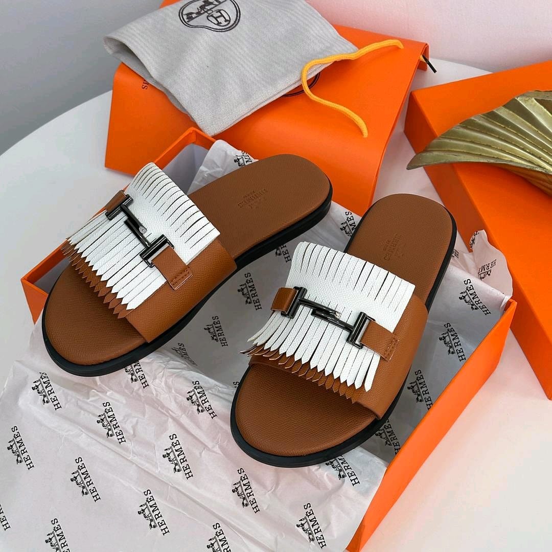 Brown Hermes slides with white fringe and H buckle inside orange boxes with dust bag.