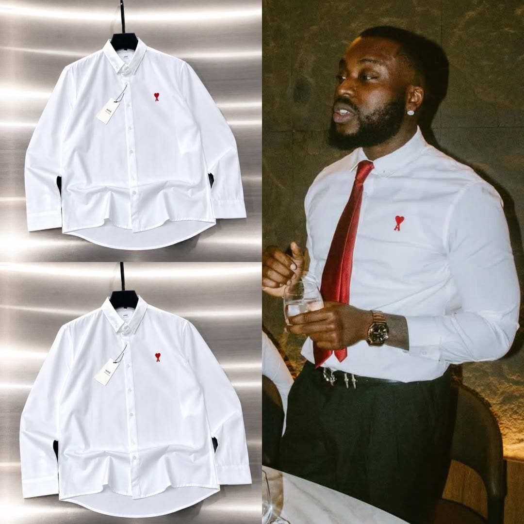 White button-down shirt with red chest logo in flat lays and worn with tie on model.