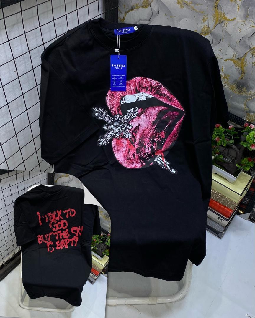 Black t-shirt with large pink lips, cross and gun graphic, plus back view with red text.