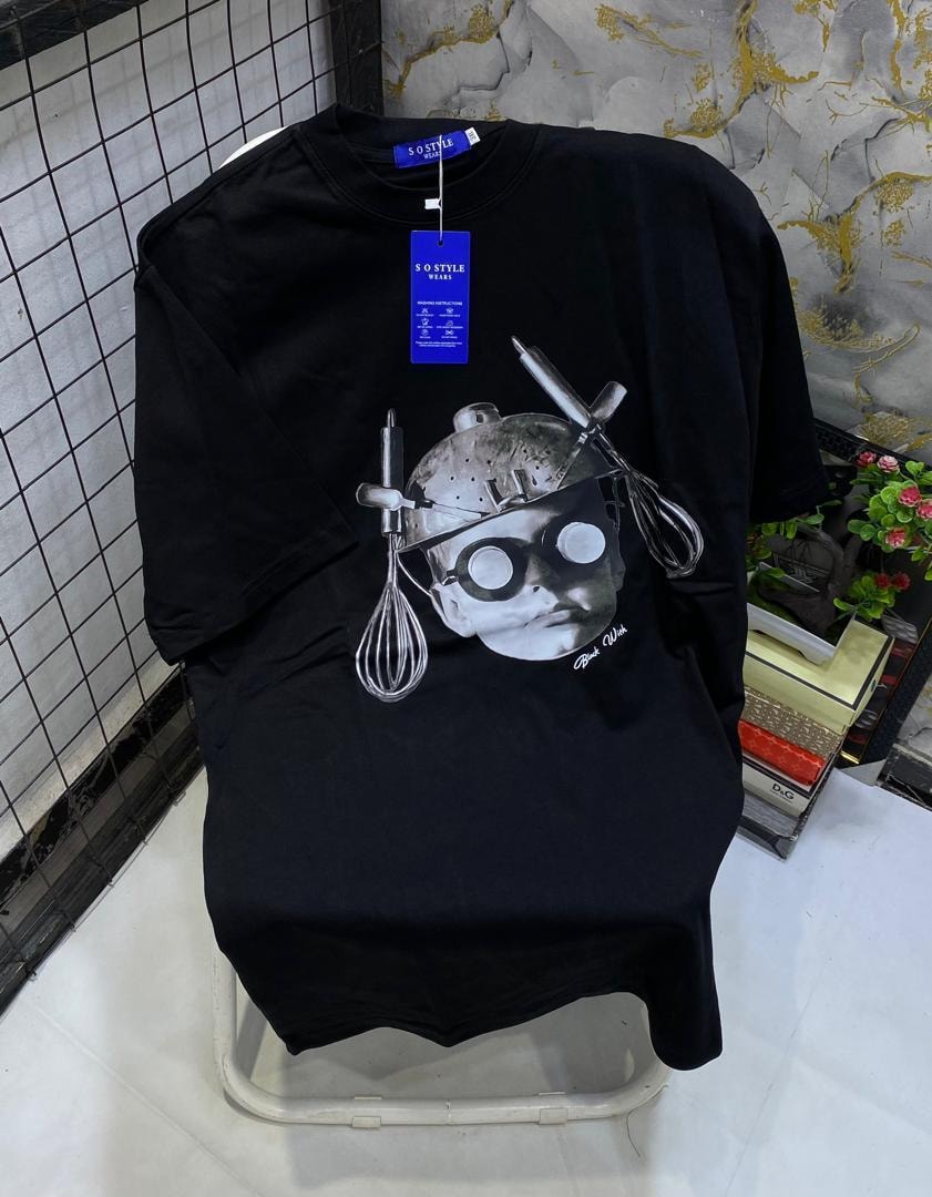 Black t-shirt displaying chef portrait graphic composed of kitchen utensils.