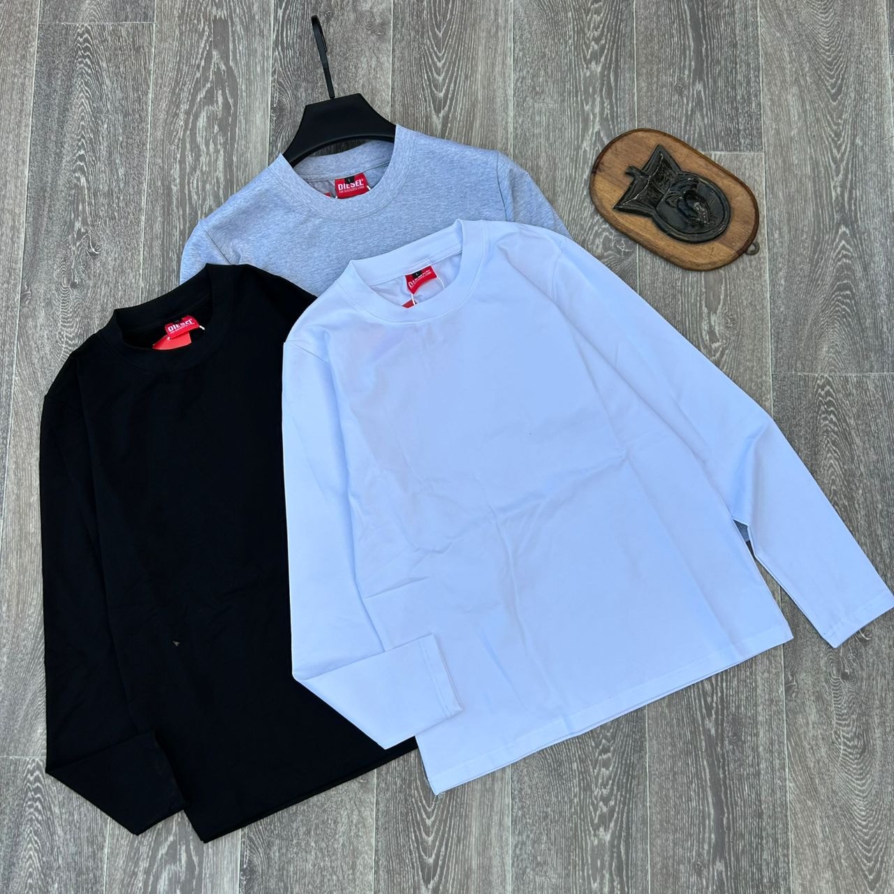 Black, white, and gray plain long sleeve body hug tops displayed together.