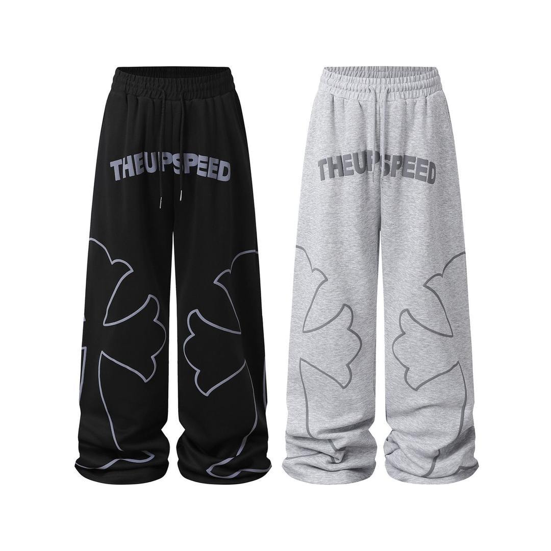 Black and grey joggers showing THEUPSPEED print and cloud line designs on the legs, displayed side by side.