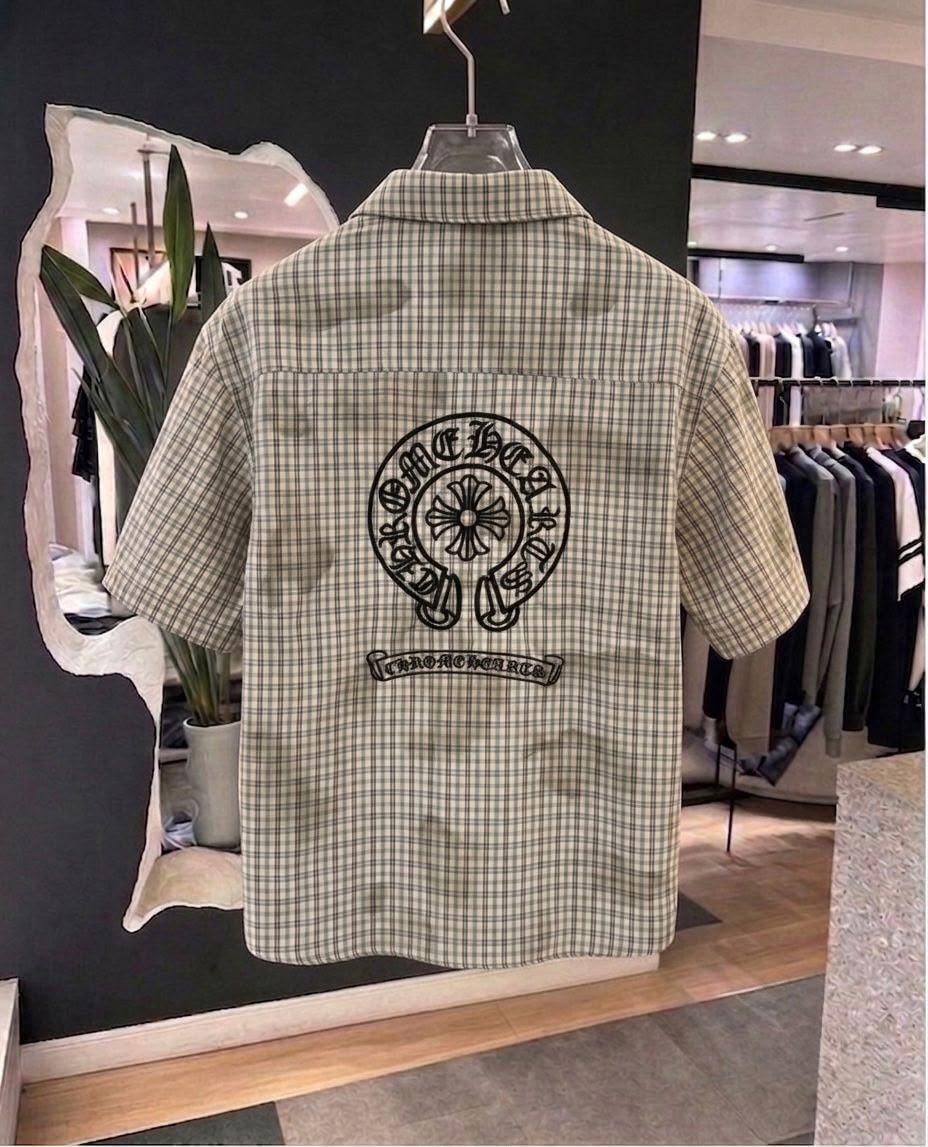 Back view of beige plaid short sleeve shirt featuring large Chrome Hearts circular graphic and text print.