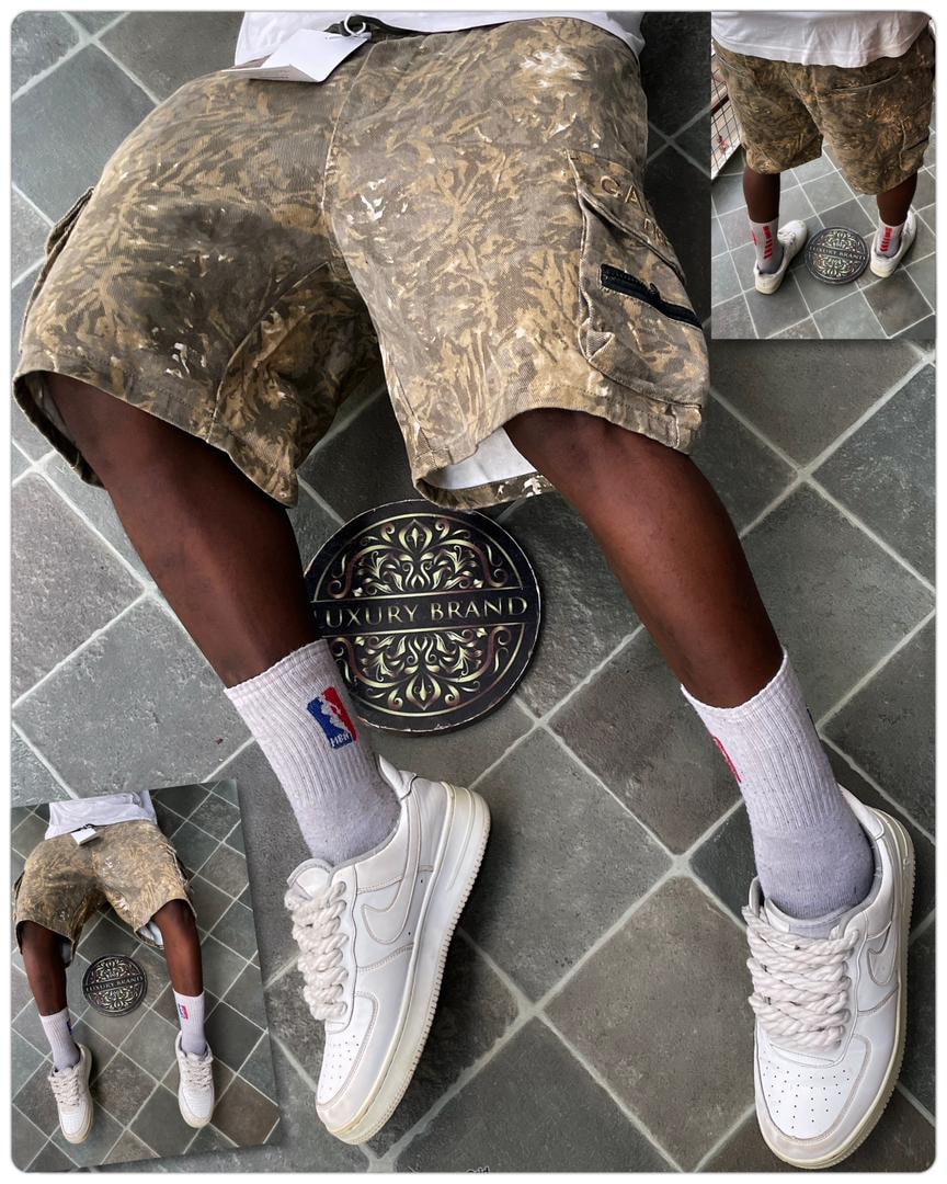 Model wearing brown camo cargo shorts with white sneakers from multiple angles.