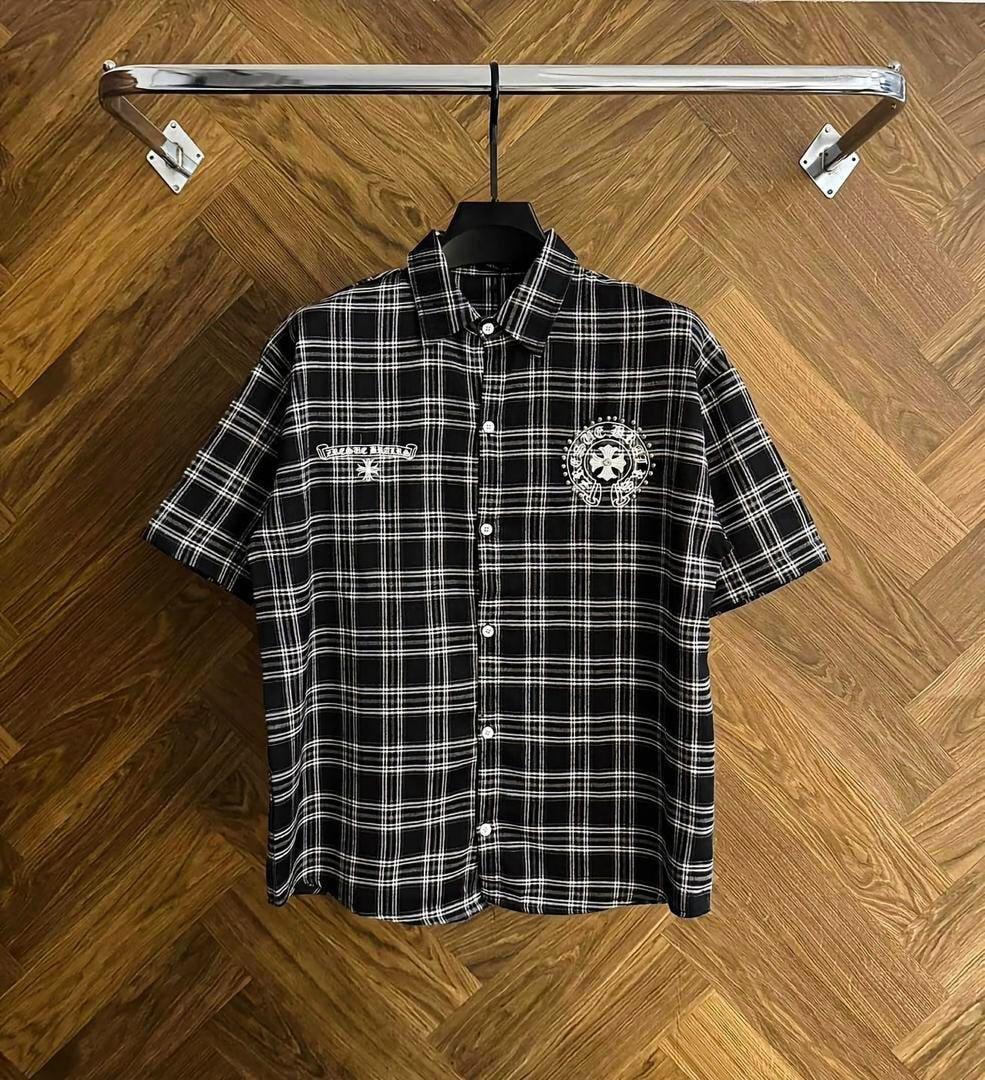 Front view of black plaid short sleeve shirt with white chest embroidery.